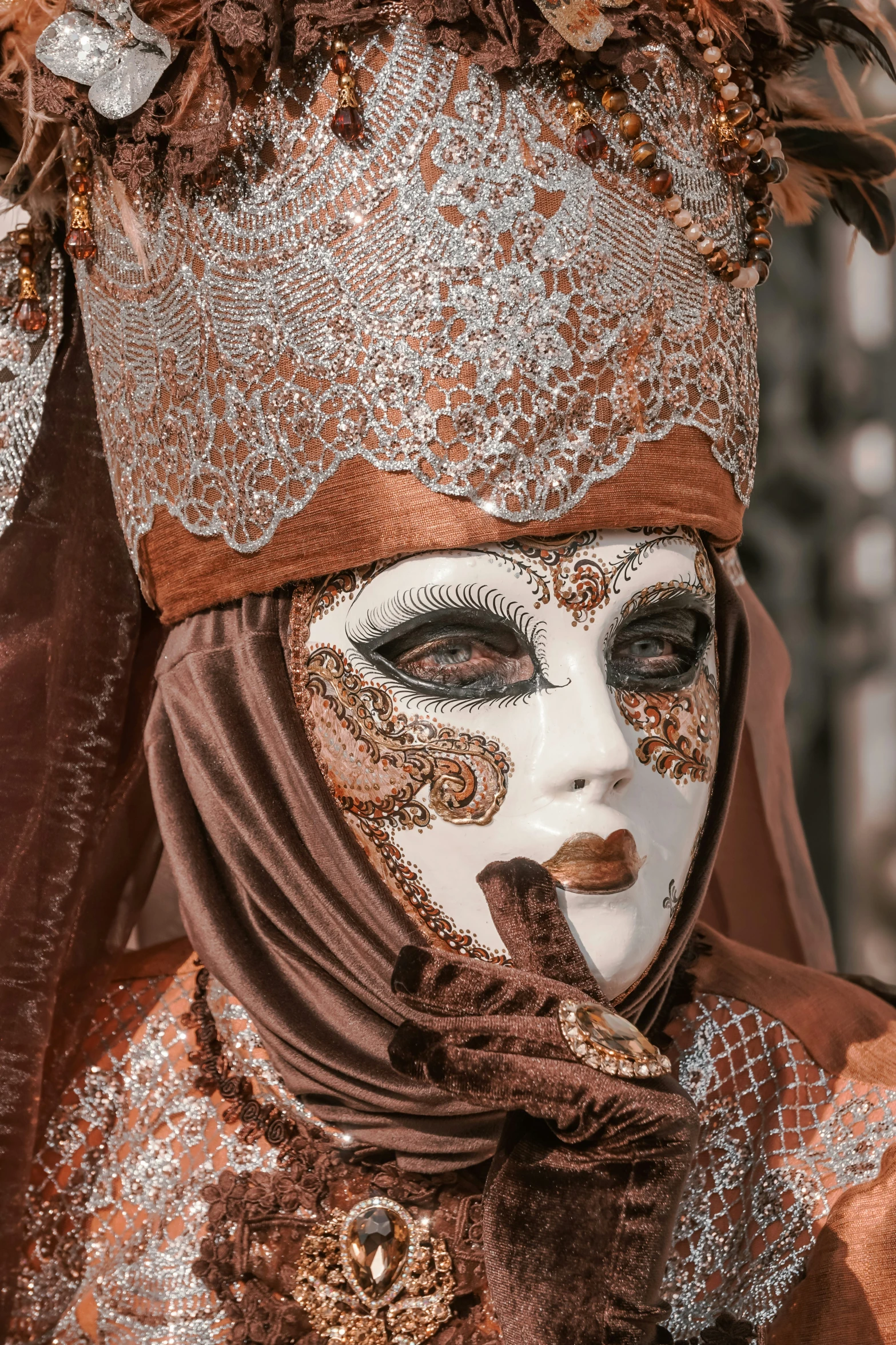 woman's mask with gold and silver decorations