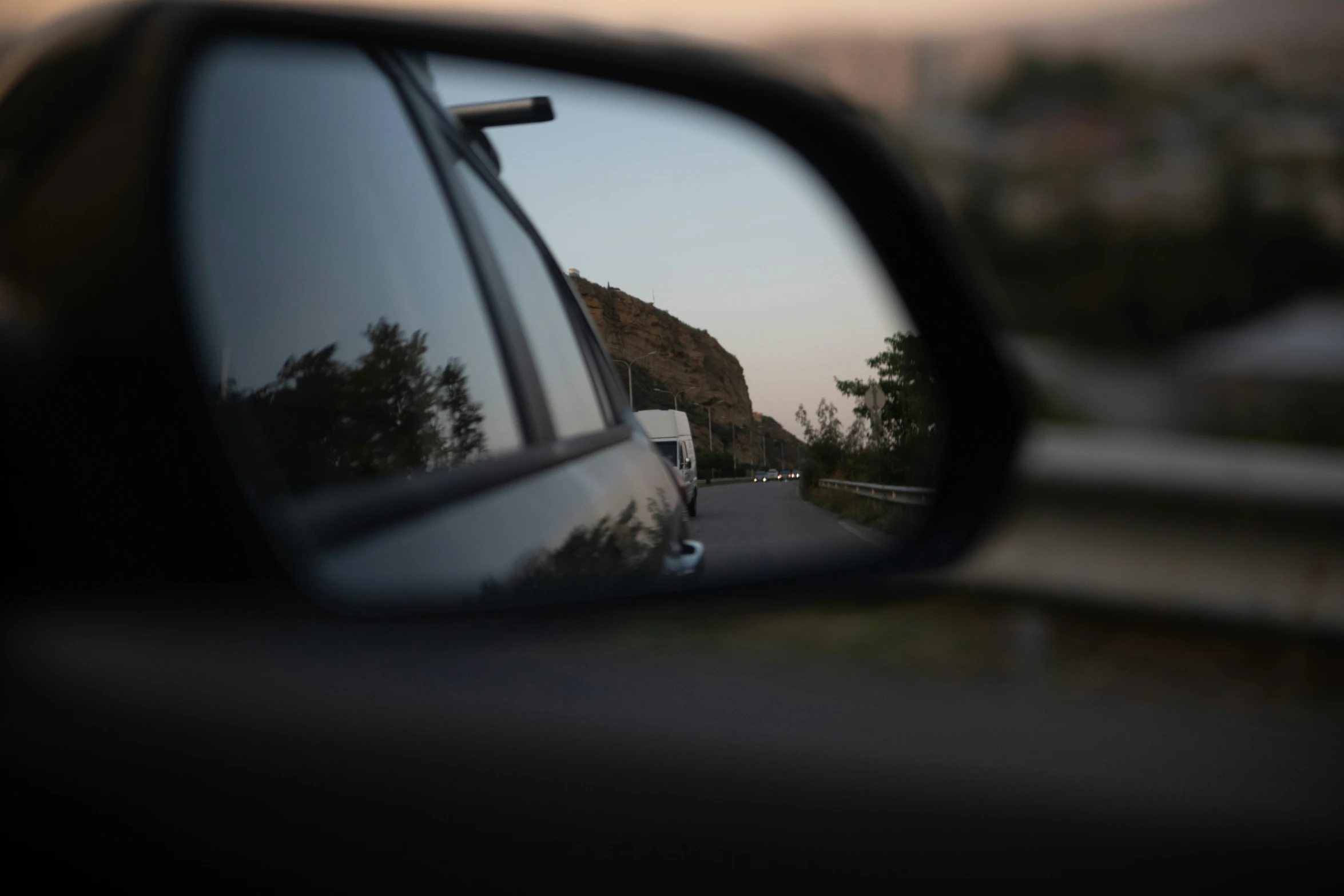 rear view mirror with a truck passing by