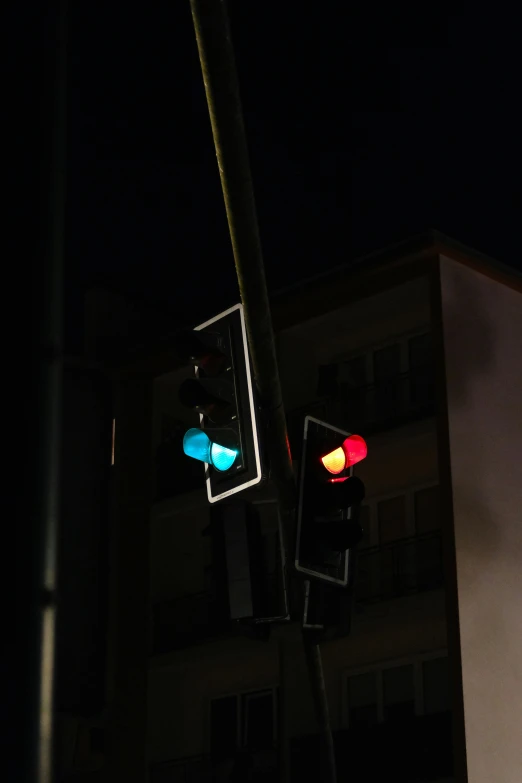 a street sign and traffic lights with some building in the background