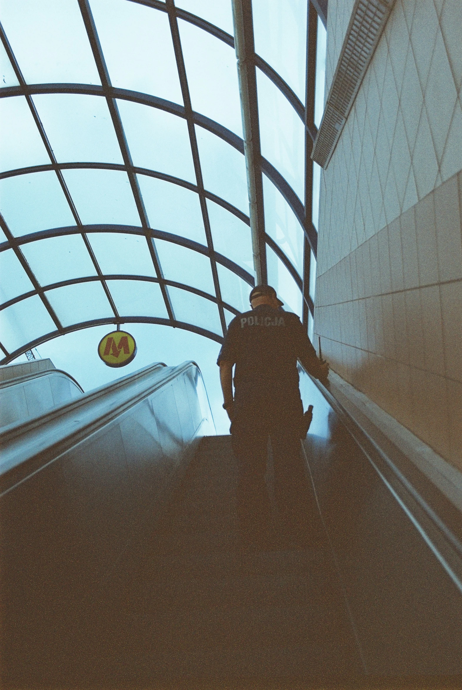 a person walking down an escalator in the middle of a walkway