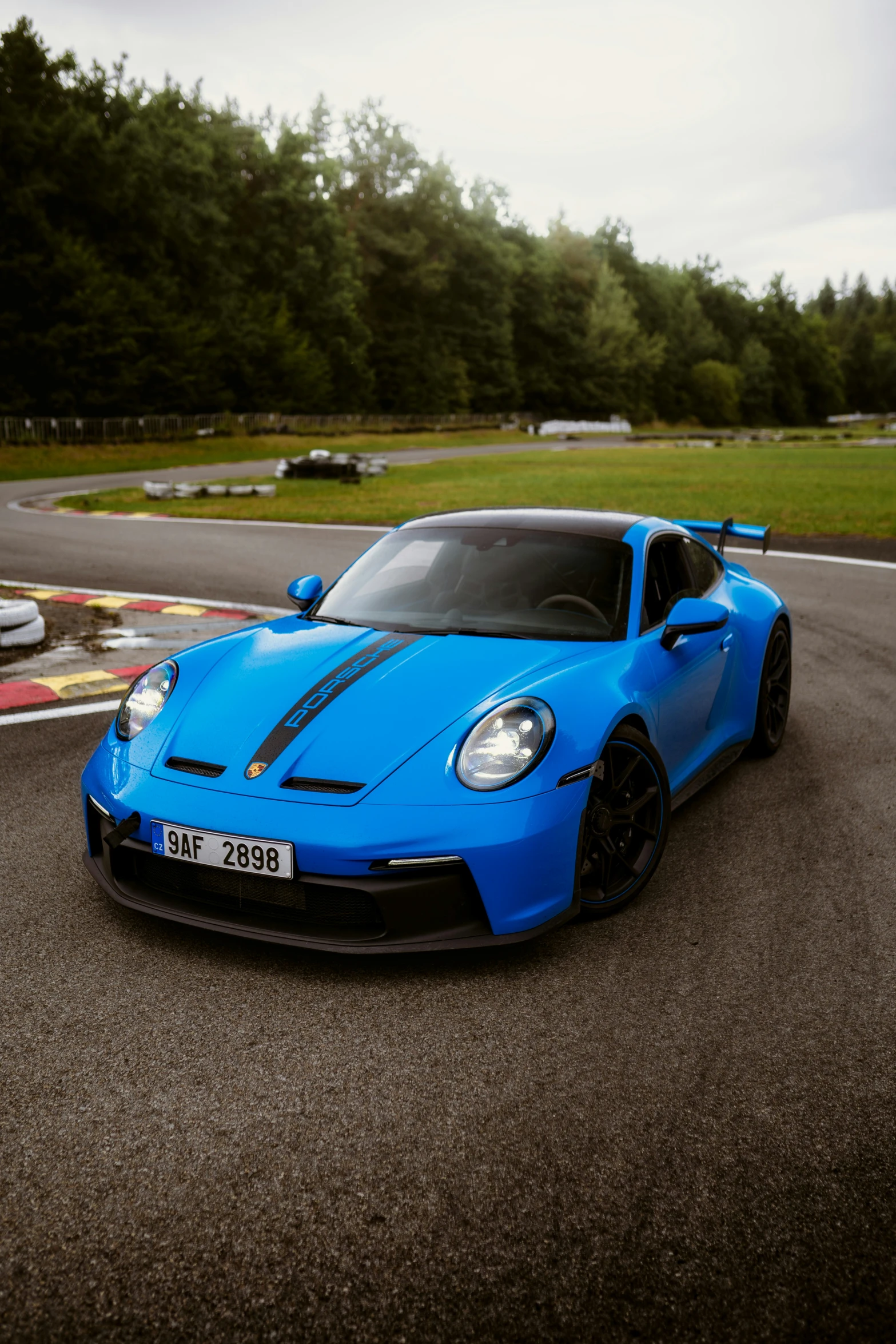 a blue sports car on the road during the day