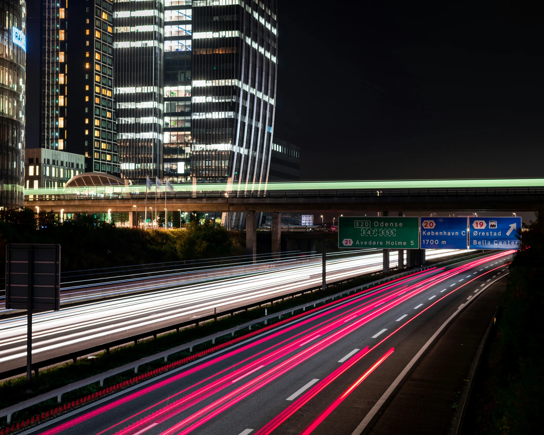 a city street filled with traffic at night