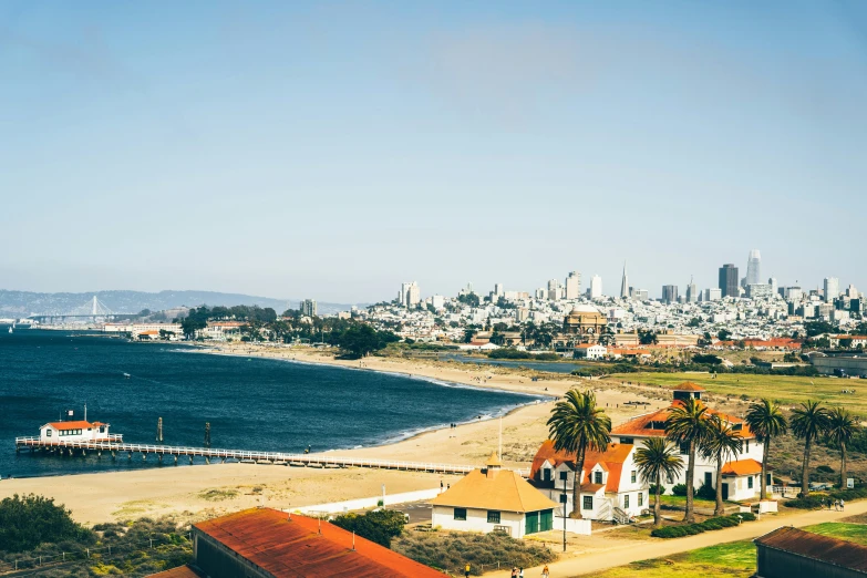 beach next to large city on blue sky day