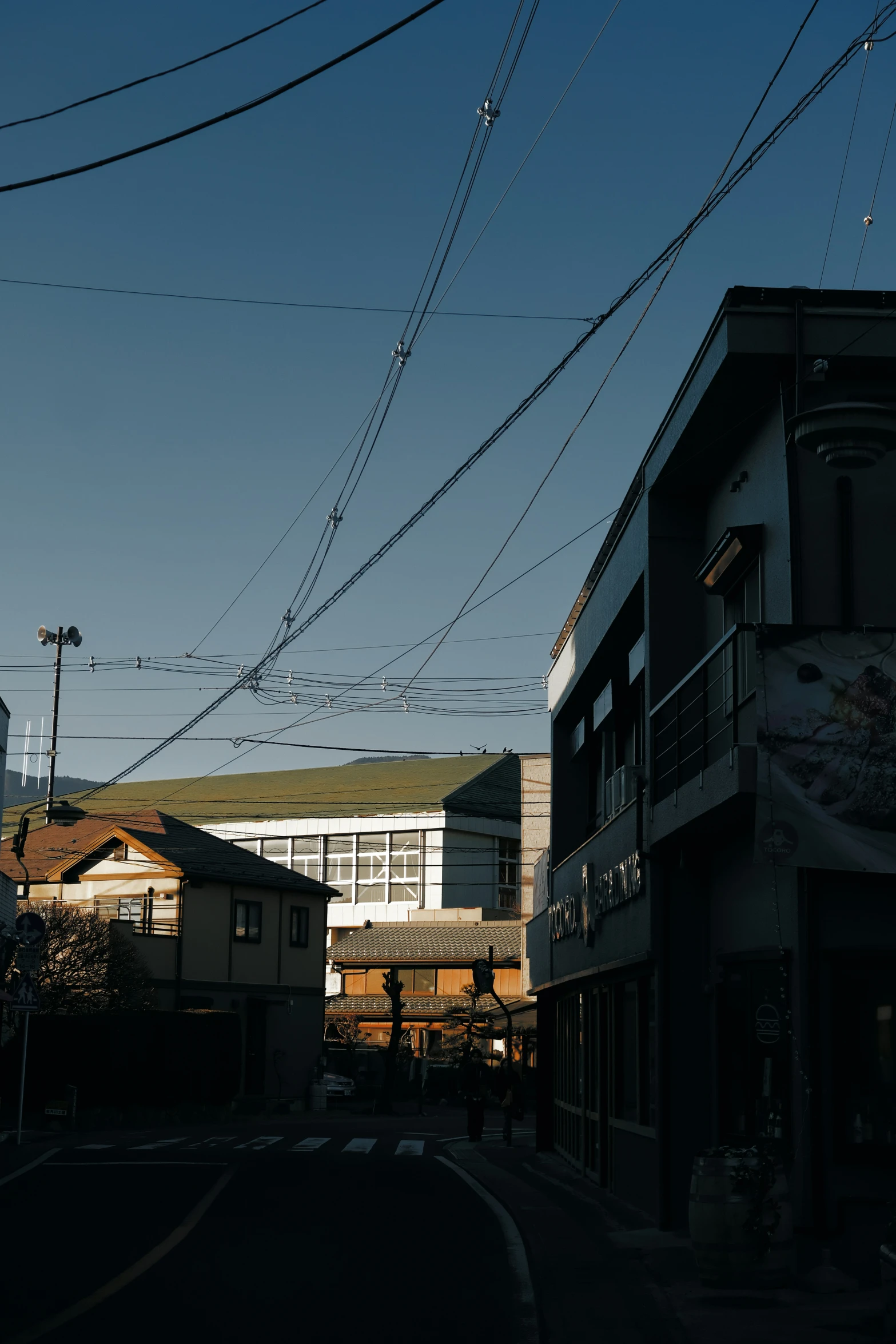 a street lined with buildings and power lines above