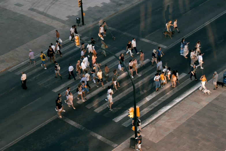 many people crossing the road in an intersection