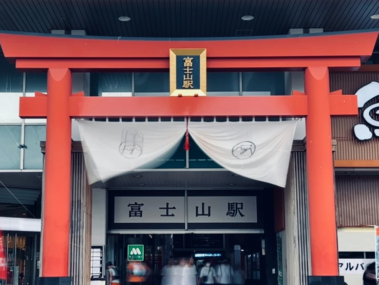 an oriental building with lots of people walking in it