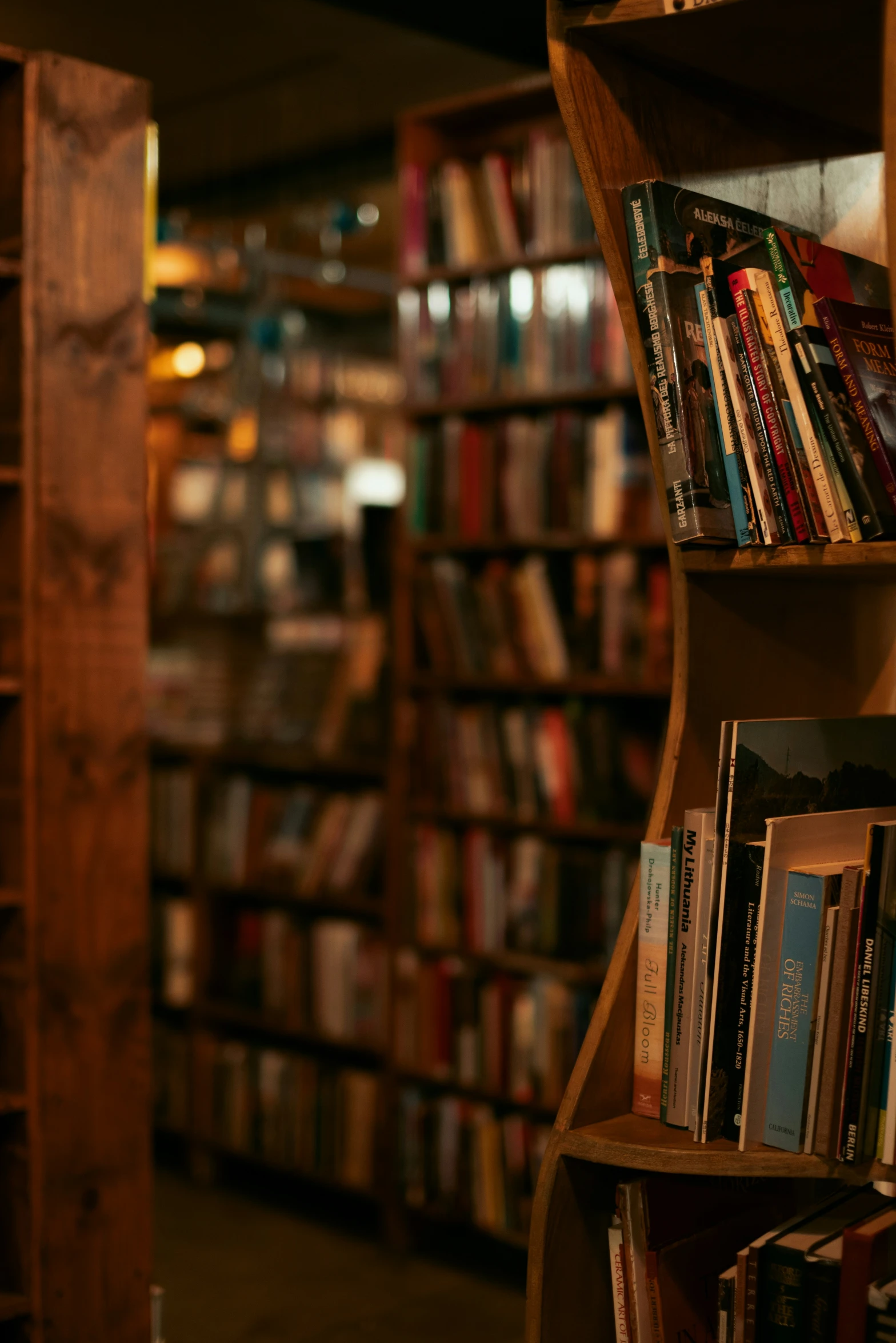 a shelf of books in a liry in the dark