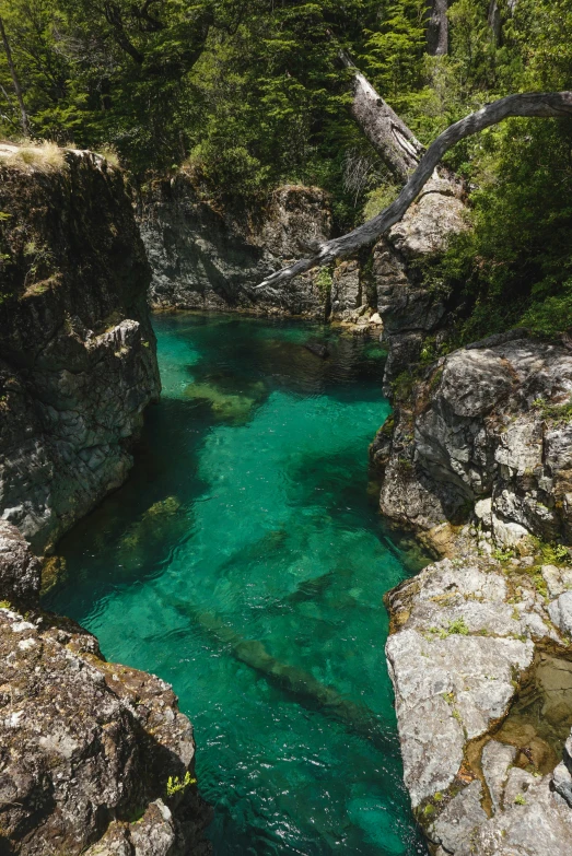 a river surrounded by rock formations with a few small rocks