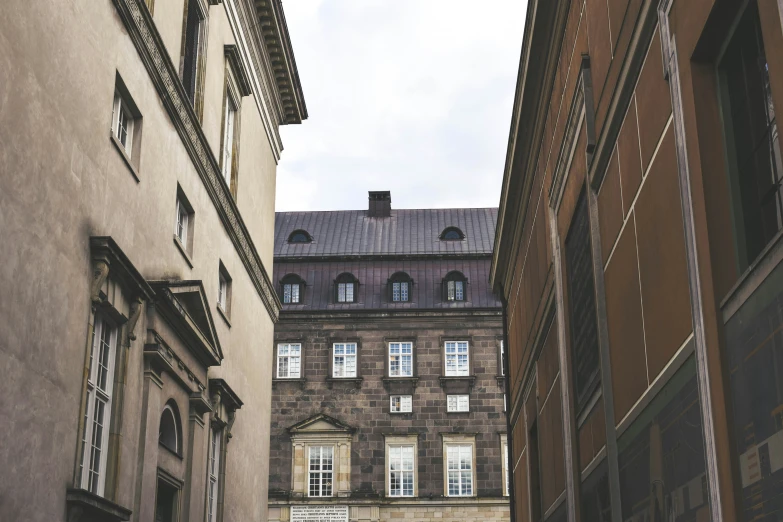 an alley way has two buildings and some signs on it