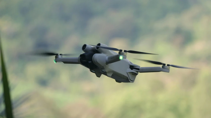 a large model aircraft flying by some tall trees