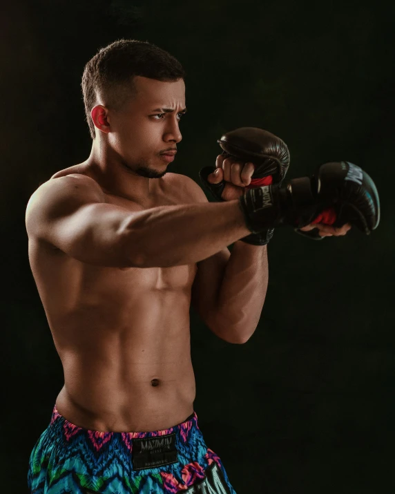 a man wearing boxer briefs holding a hand punch glove