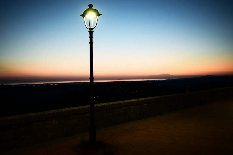 an old fashioned street lamp in the middle of nowhere