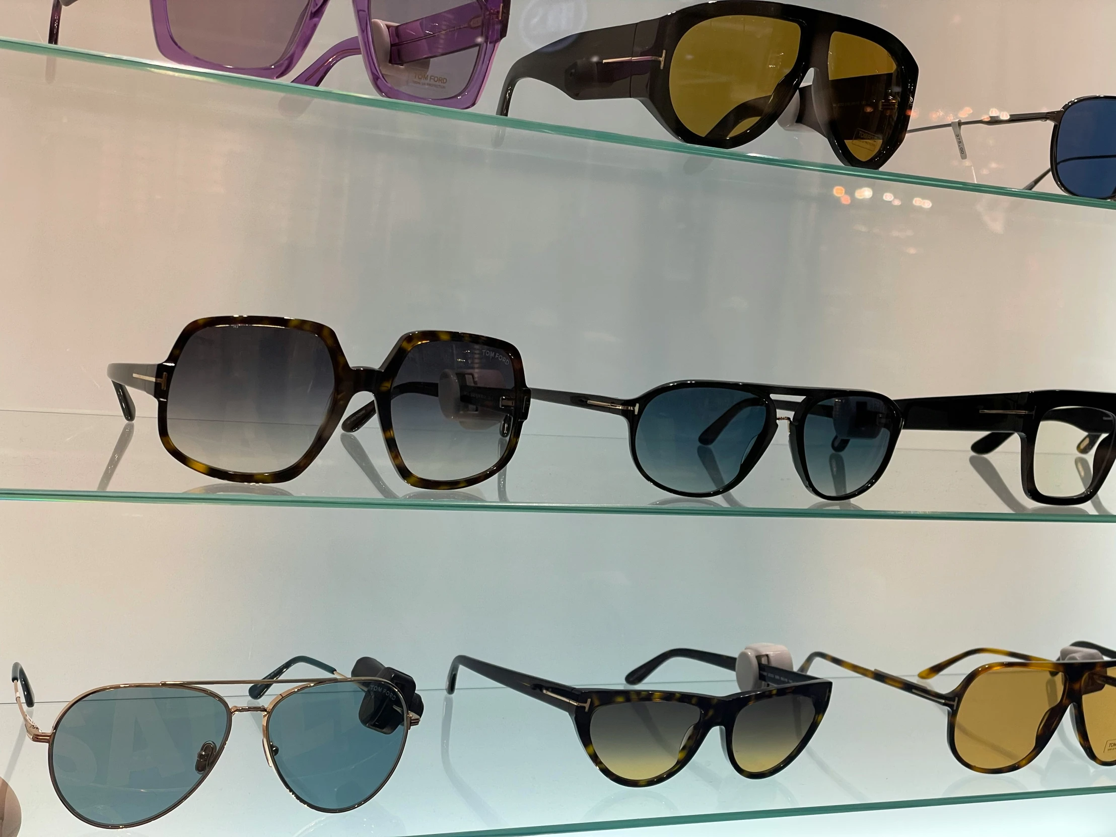 a display case that has many different sunglasses on it