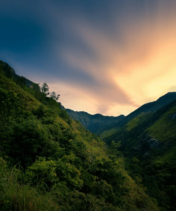 mountain with clouds and greenery near sunset