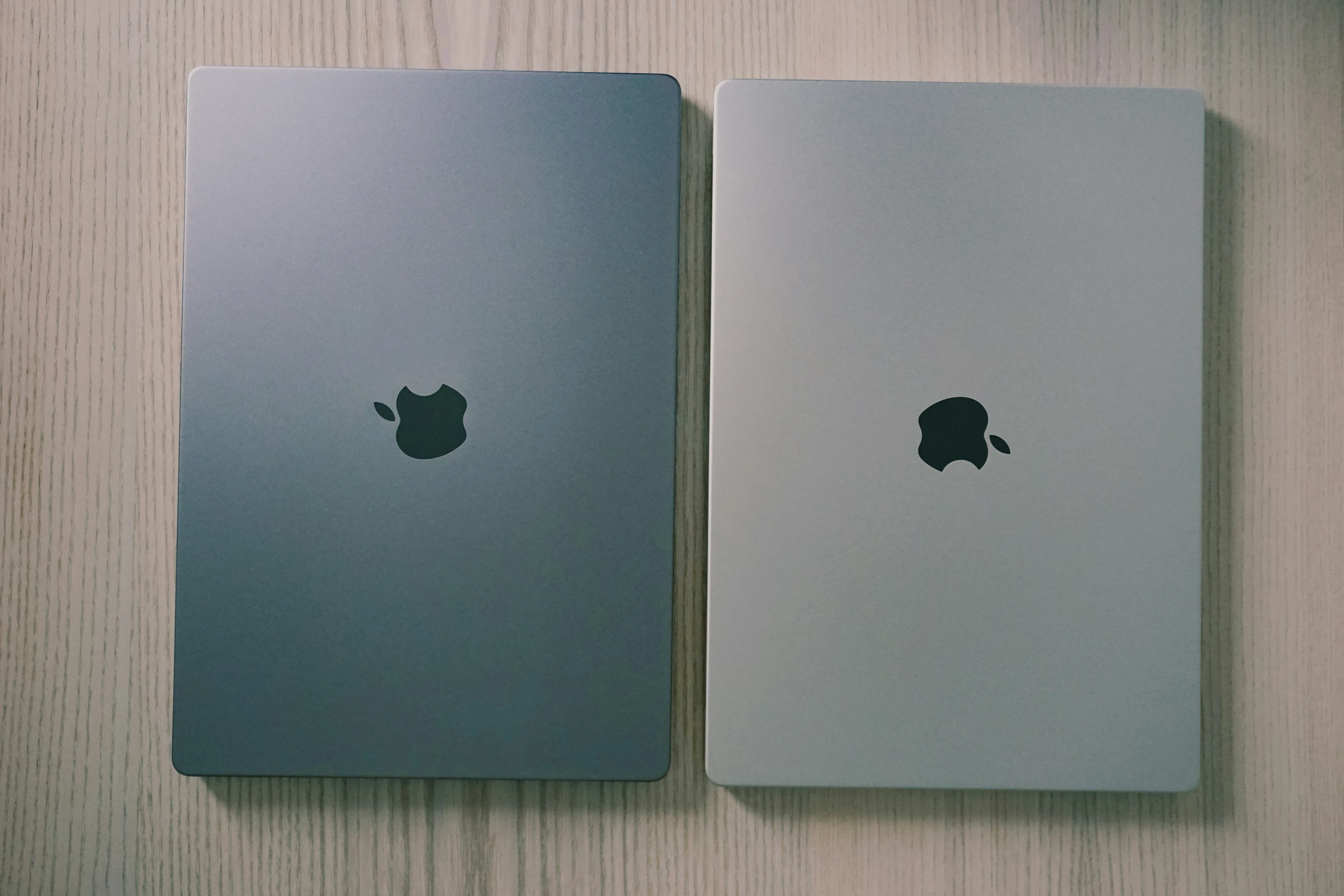 two silver ipads that are sitting side by side