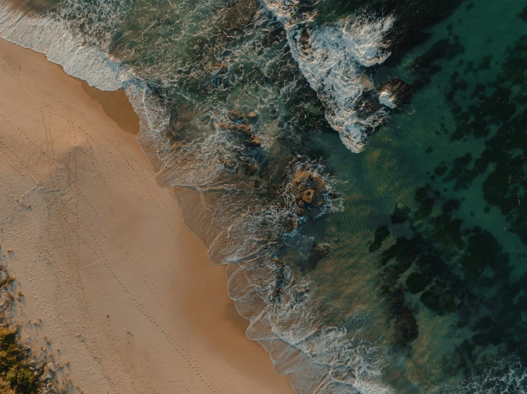 a bird's eye view of a beach and water