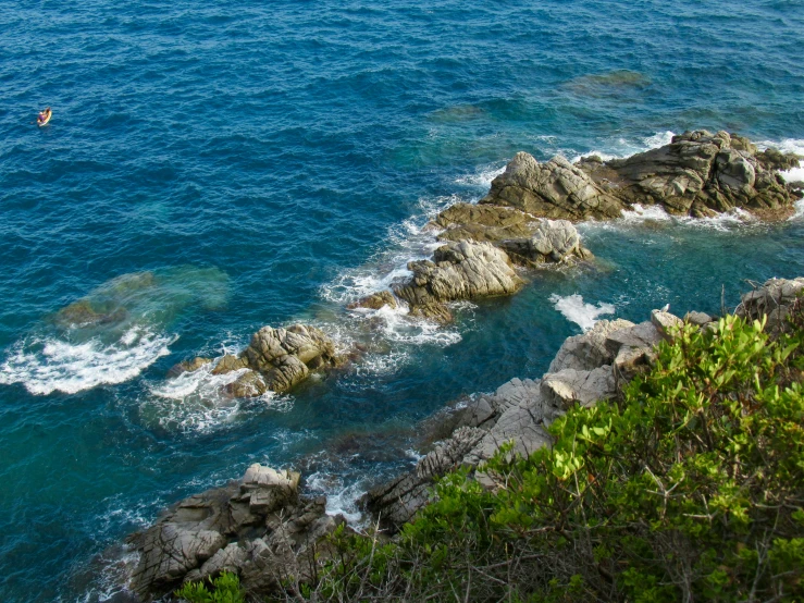 an image of some blue water and rock formation