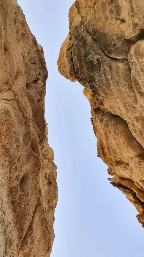 a po of a man climbing on top of a cliff