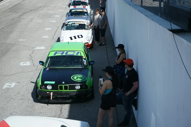 a line of cars are lined up against a wall