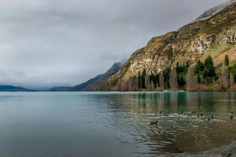 a large body of water with mountains in the background