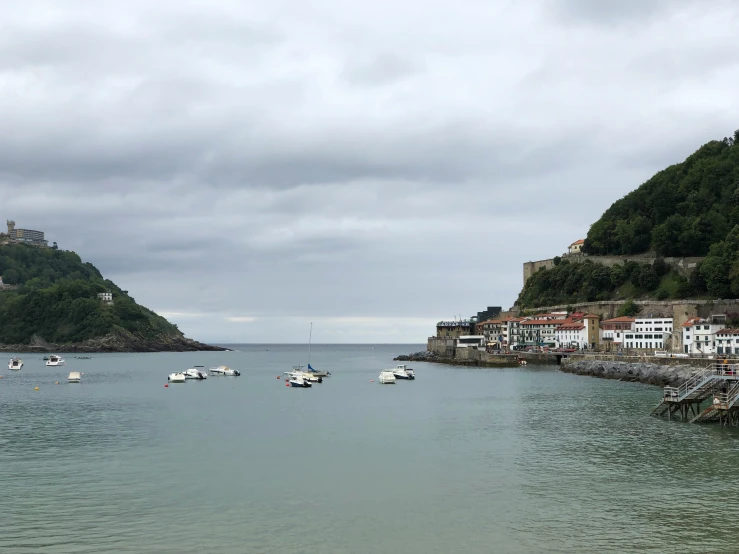 boats are floating on the water near the shore