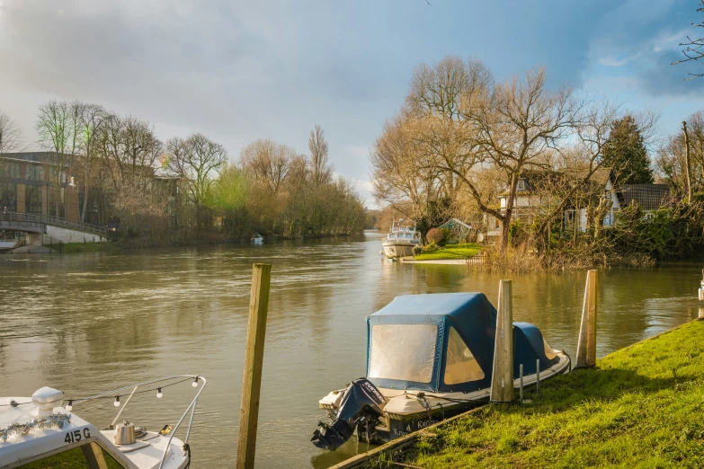 there are boats parked along the side of the river