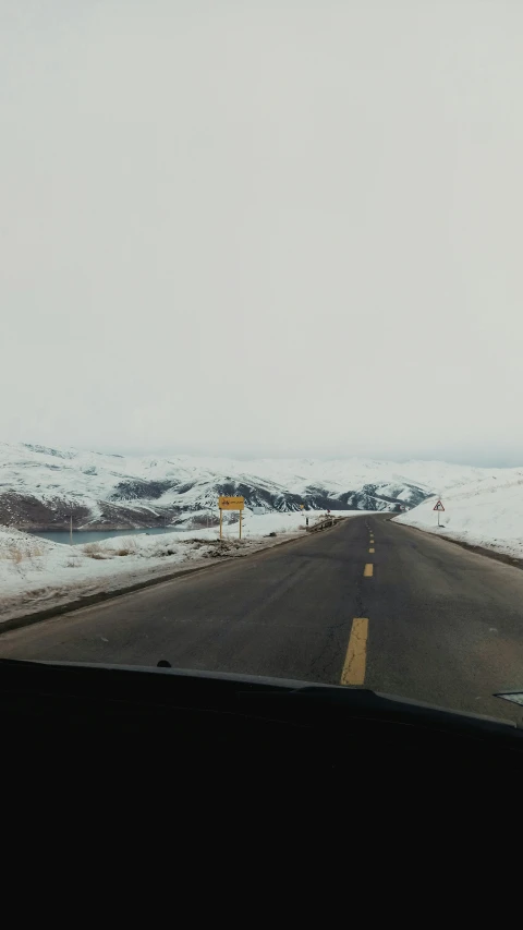 a view of a road through a car windshield