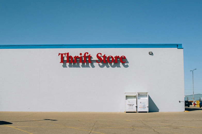 a thrift store storefront in front of a blue and white building