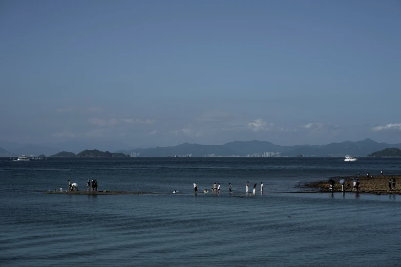 a body of water with people standing around it