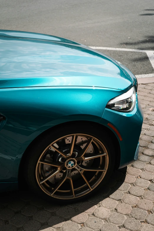 the wheels of a blue sports car parked on a street