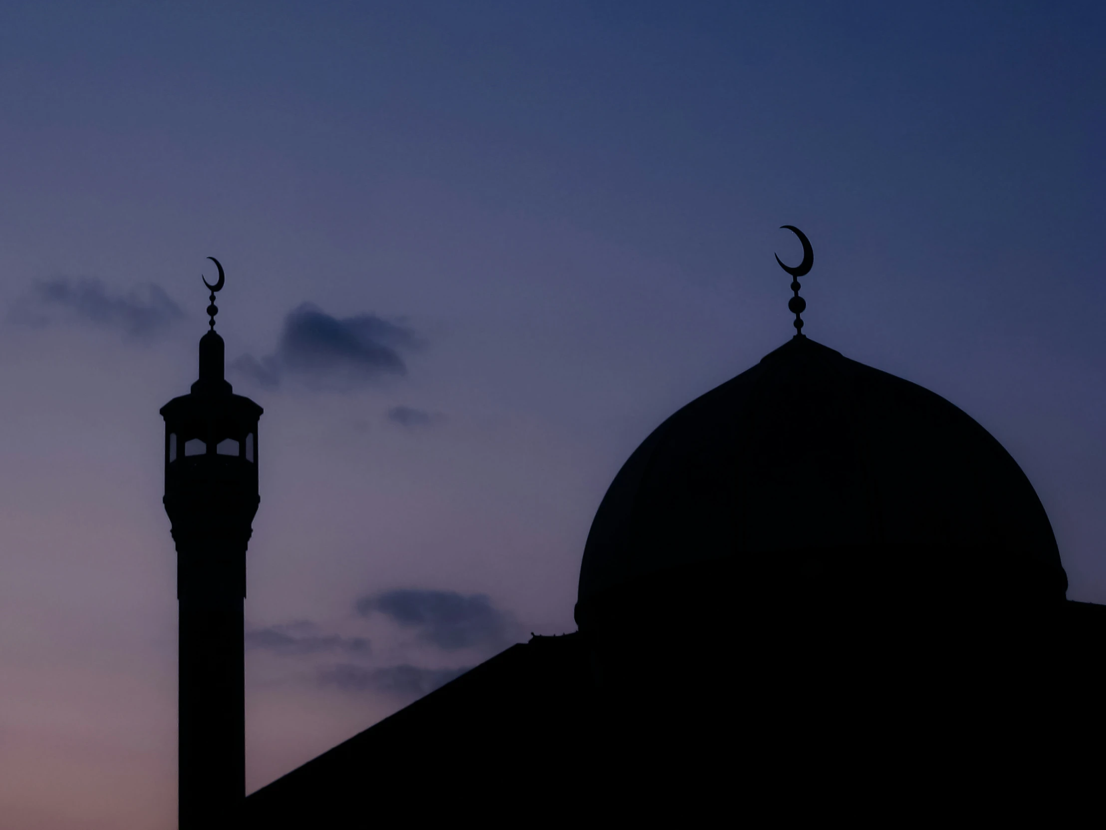 an arabic styled mina minage silhouetted against the night sky