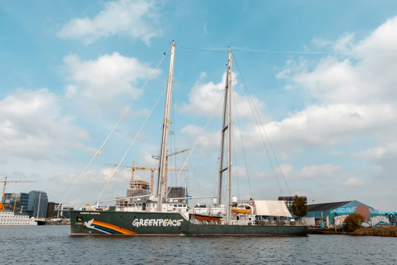 a large, black ship moored at a dock