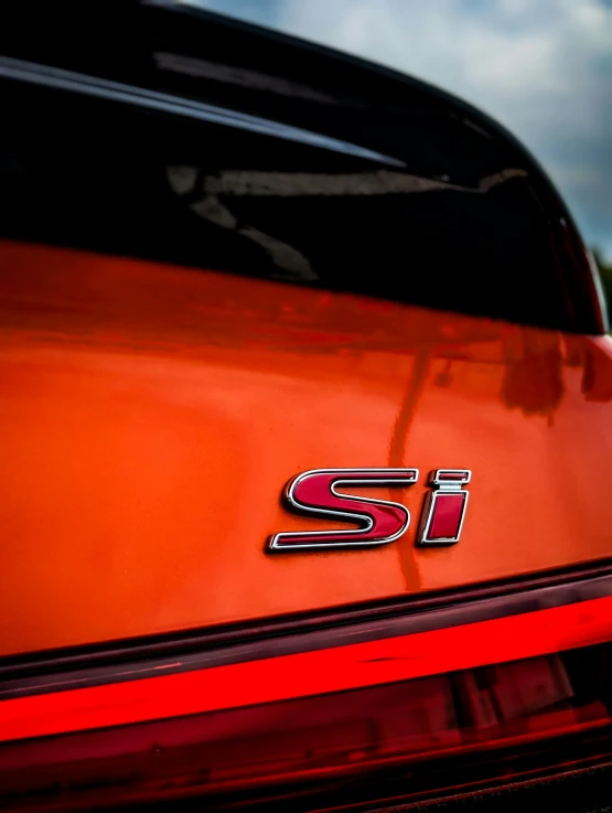 an orange and black sports utility truck with chrome sii lettering