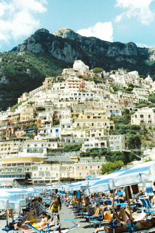 beach chairs, umbrellas and buildings line the hillside