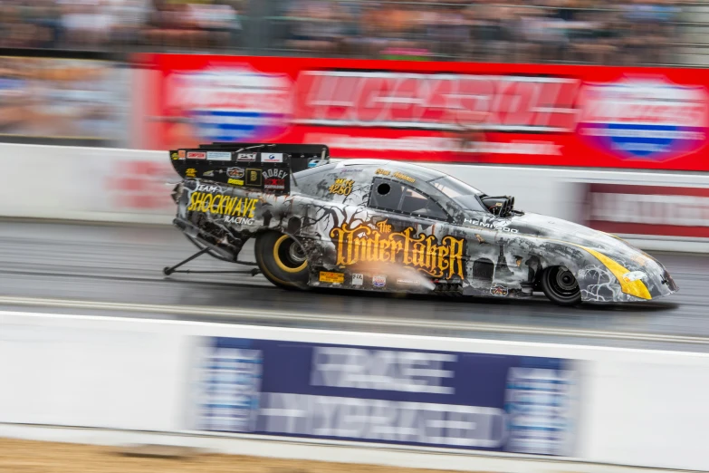 a car with paint covered driving on a track