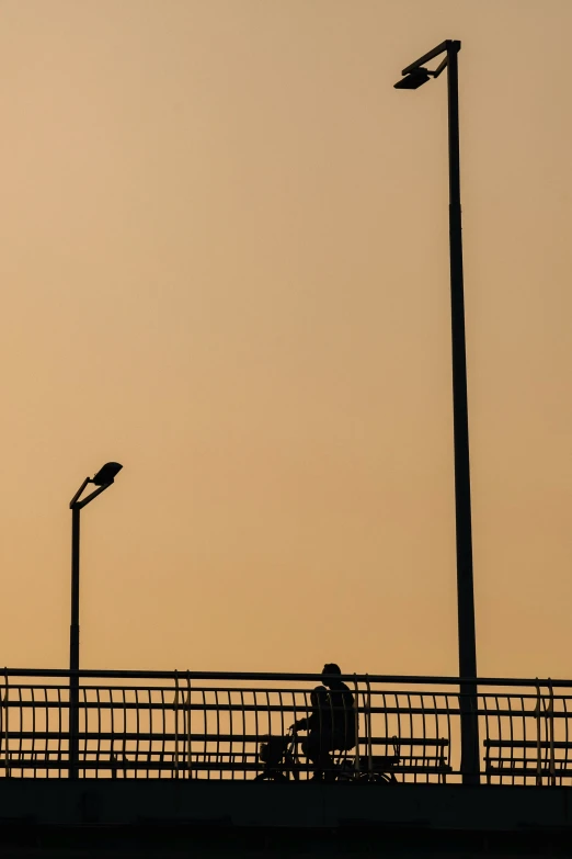 a man is looking at the light posts above him