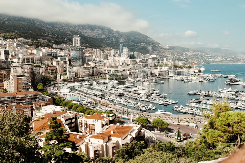 a marina with boats in it and buildings with mountains around