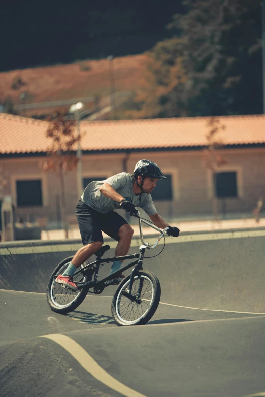 a man is riding a bike in a parking lot