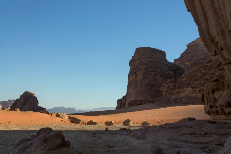 a barren desert with rocks and hills on it
