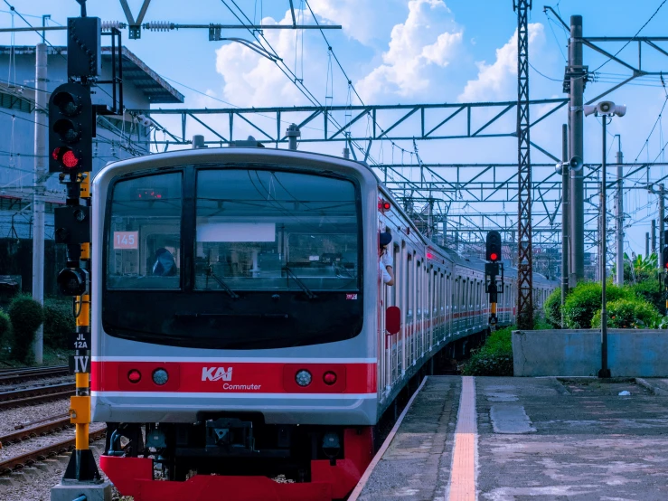 the commuter train is moving along its tracks