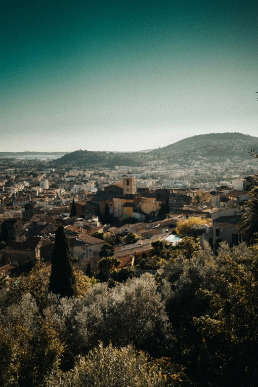 a small village on a hilltop next to some trees