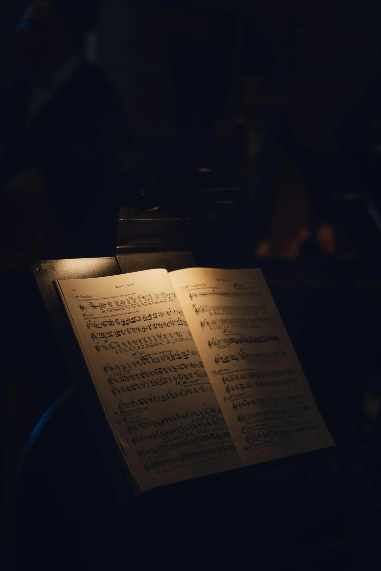 two books of musical notes on a table