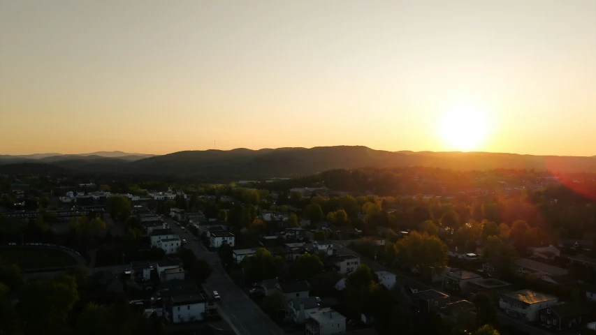 a sunset view with some houses in the background