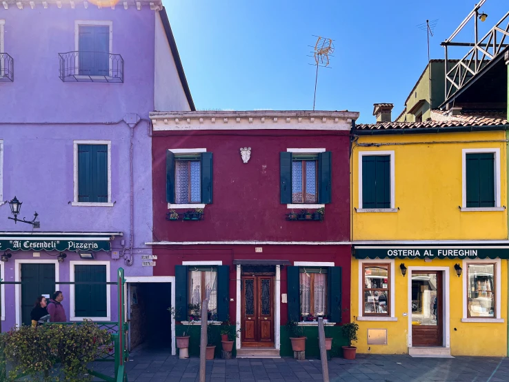 colorful buildings line a cobblestone street in town