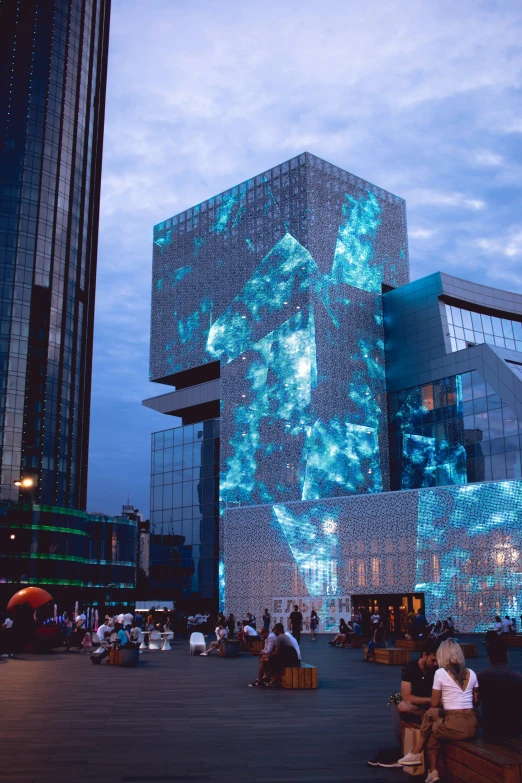 a group of people sitting in front of a building