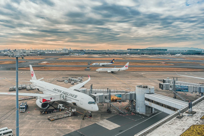 an airport area with many parked planes and airplanes