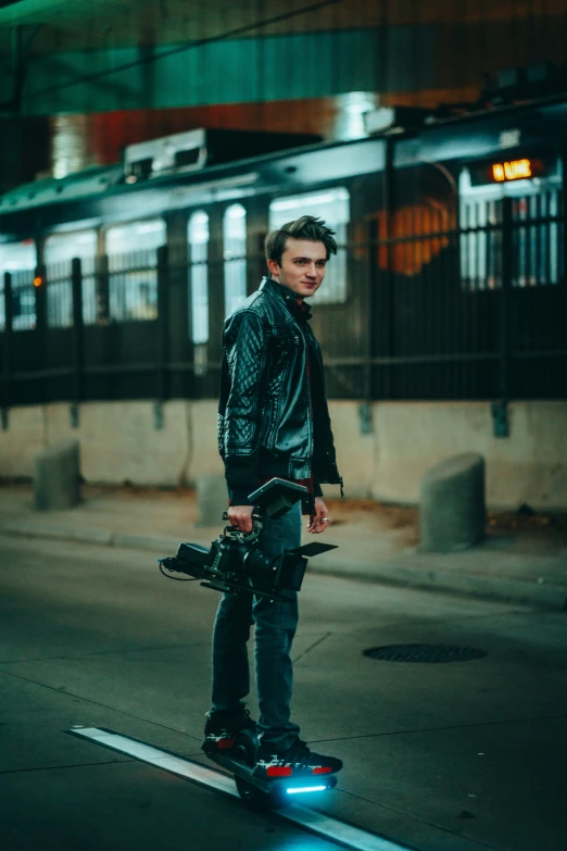 a man in a leather jacket stands on his skateboard