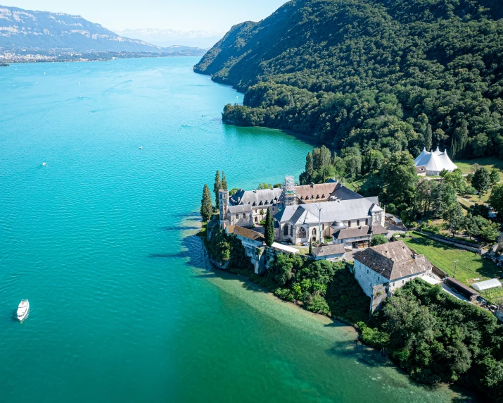 an aerial view of an estate on the shore of a lake with its boat