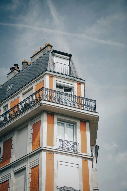 an orange and white building with a black roof