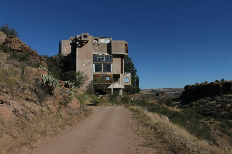 a house sitting on top of a lush green hillside